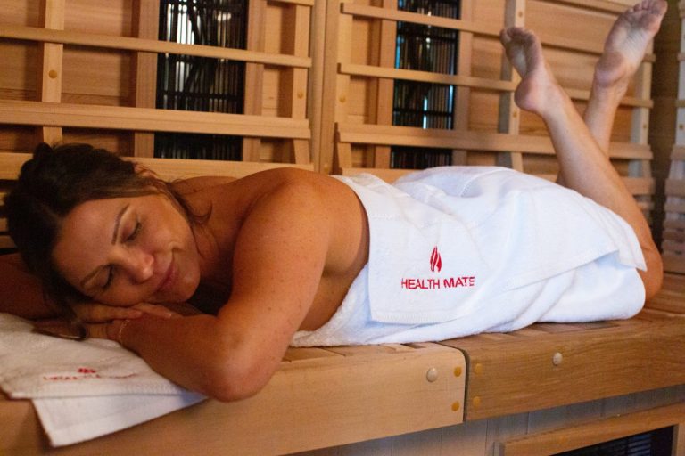 Woman relaxes and detoxes in her Health Mate Infrared Sauna