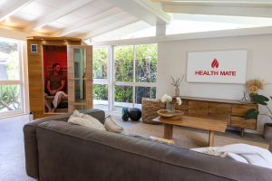 man sitting in his enrich 2 health mate infrared sauna